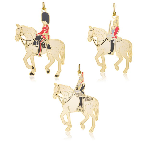 British Military Soldiers on horseback set featuring a three gold-finished, brass mounted horse and soldiers in traditional uniform. A luxurious holiday decoration inspired by the historic British regiments.