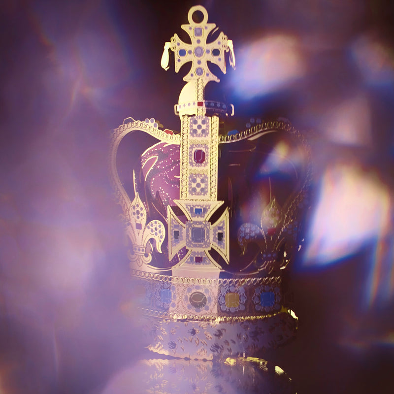 Handcrafted St Edward’s Crown Christmas Tree Ornament, hidden behind crystal, featuring intricate 24-carat gold detailing and vibrant jewel embellishments. A royal symbol of British heritage by The London Christmas Company.